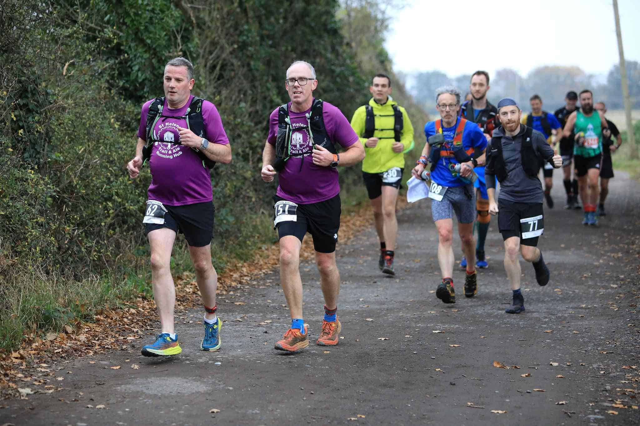 Warrington Way Ultra showing athletes racing on the course along a quiet country lane.